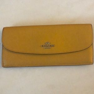 Leather Coach brand wallet mustard yellow color